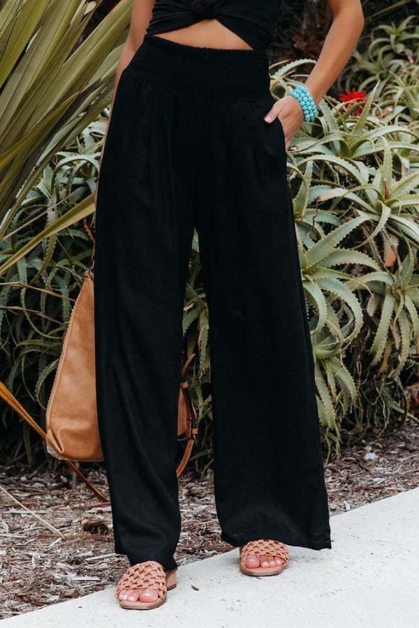 Elegant women's wide leg pants with a smocked high waist, perfect for resort and casual wear.