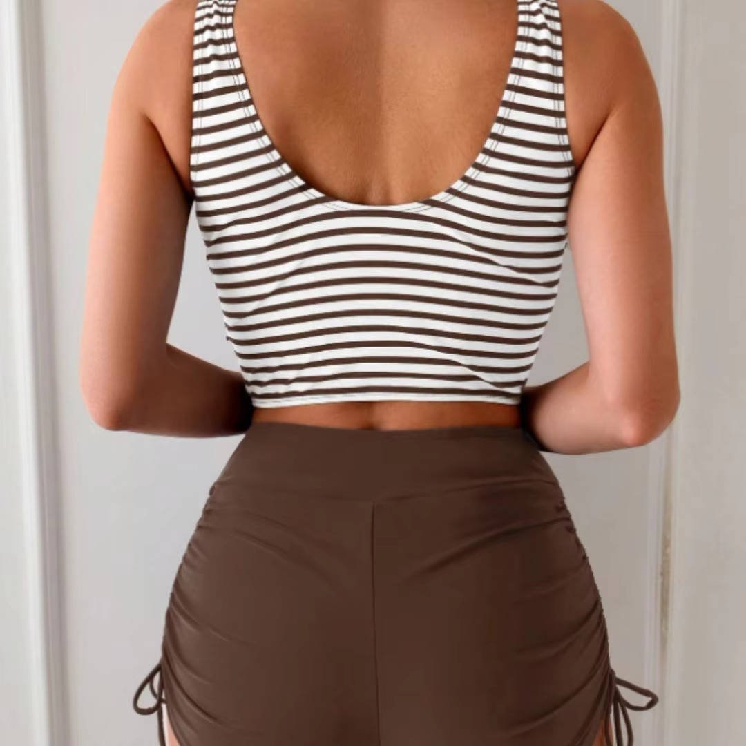 Women's high-waisted tankini set with an elegant cross-wrap top, perfect for summer vacation.