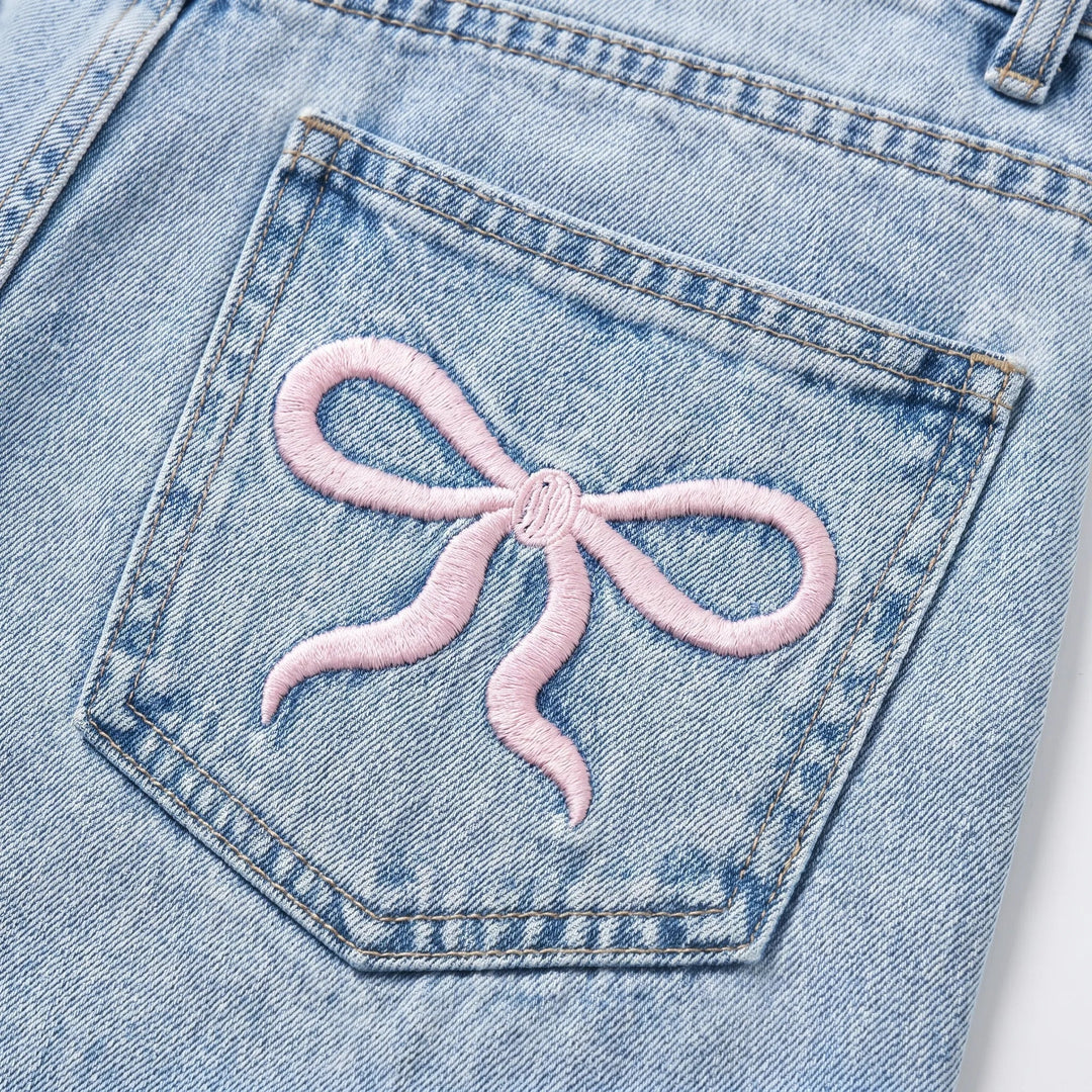 Light wash wide-leg women's jeans featuring a flattering high waist and unique cherry embroidery. Casual & stylish.