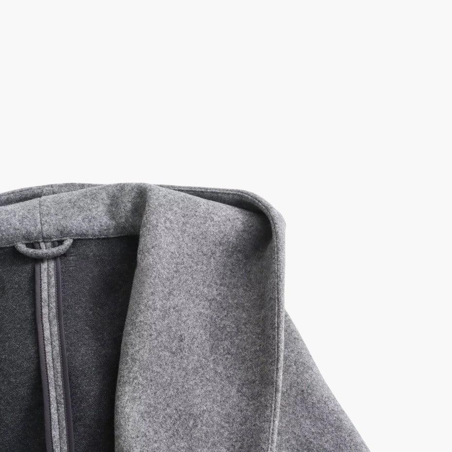 Chic women's hooded trench coat, belted for a flattering fit, perfect for fall and spring weather.