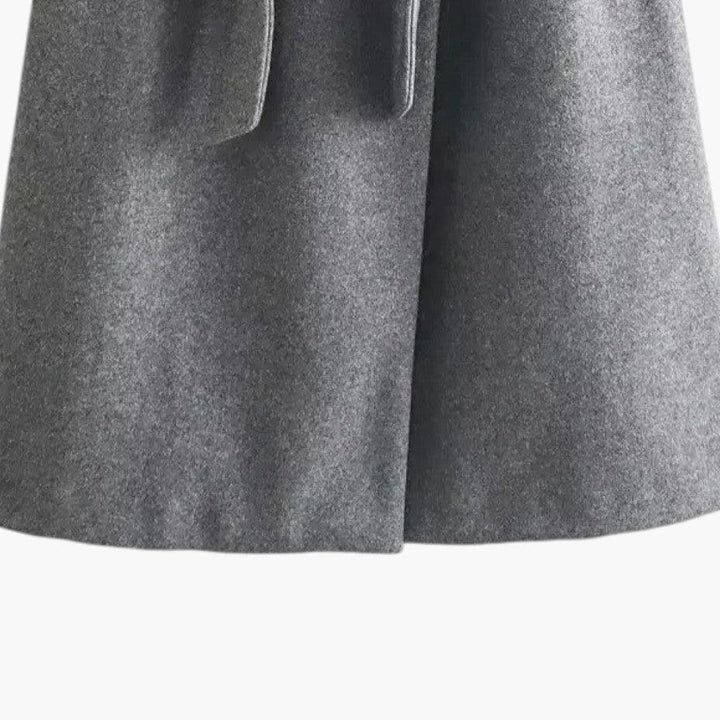 Detail of the hood and belted waist on a women's chic trench coat, ready for fall/spring.
