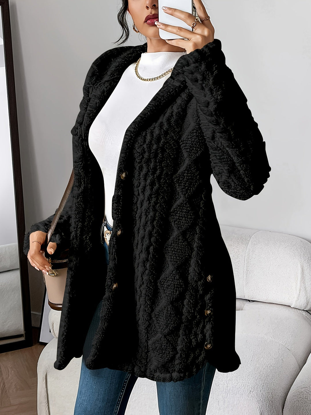 Stylish women's long hooded coat featuring a button-front. Warm and chic outerwear for fall and winter fashion.