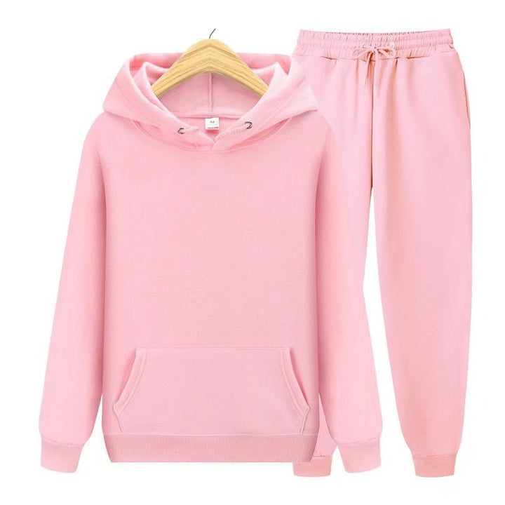 Grey women's matching hooded jogger set. Relaxed fit sweatshirt and pants, perfect for comfort.