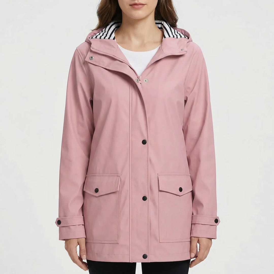 Water beads off a women's waterproof outdoor jacket, showcasing its reliable protection from rain.