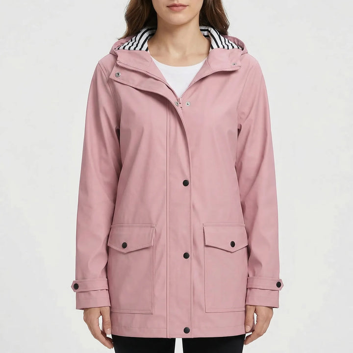 Water beads off a women's waterproof outdoor jacket, showcasing its reliable protection from rain.