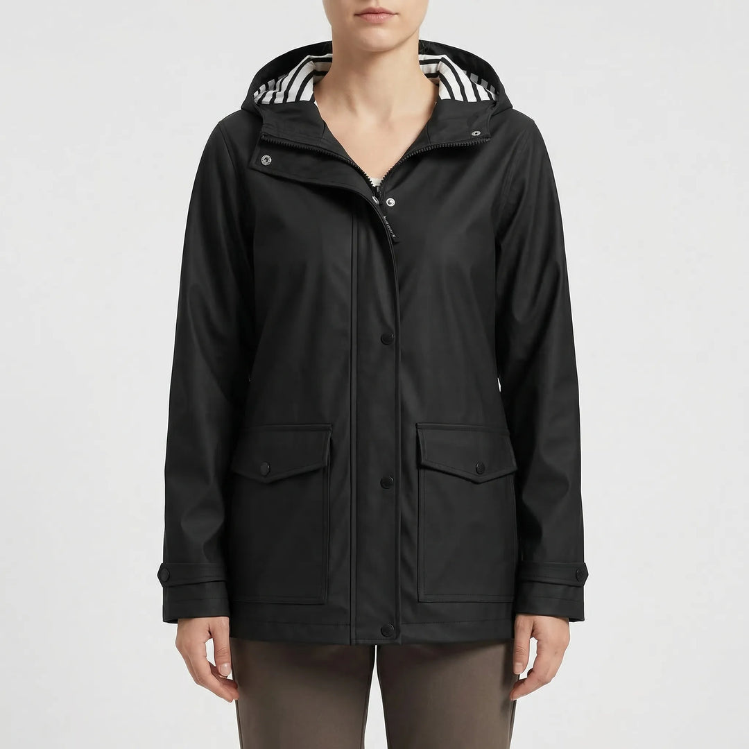 Close-up of durable waterproof fabric & adjustable hood on a women's rain jacket for outdoor activities.