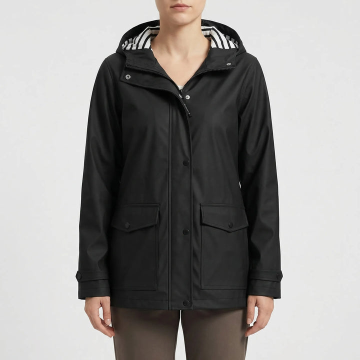 Close-up of durable waterproof fabric & adjustable hood on a women's rain jacket for outdoor activities.