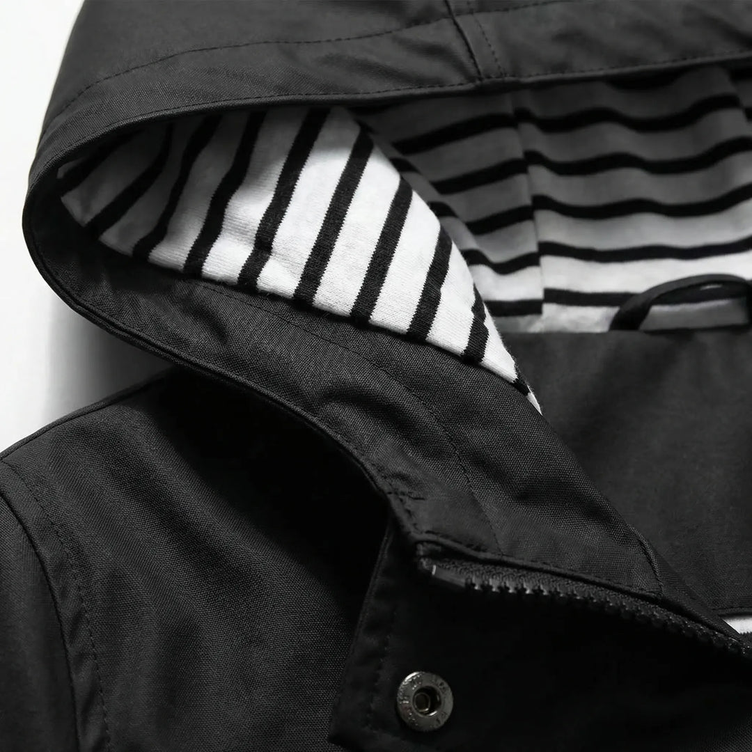 Woman hiking confidently in a lightweight waterproof hooded jacket, ideal activewear for fall adventures.