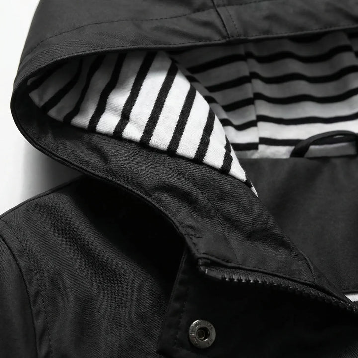 Woman hiking confidently in a lightweight waterproof hooded jacket, ideal activewear for fall adventures.