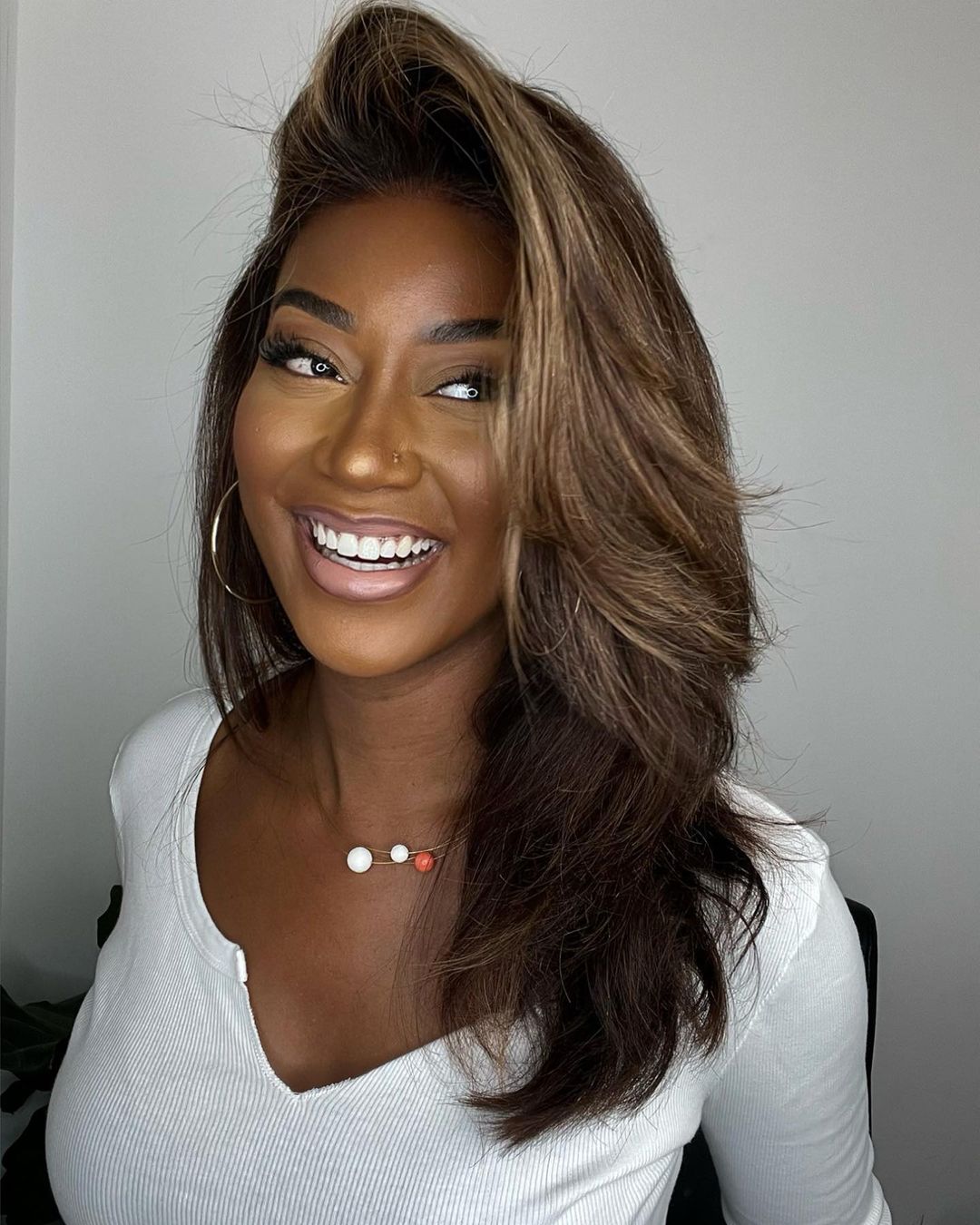 Natural-looking women's lace front wig with stunning blonde highlights, soft waves & comfortable fit.