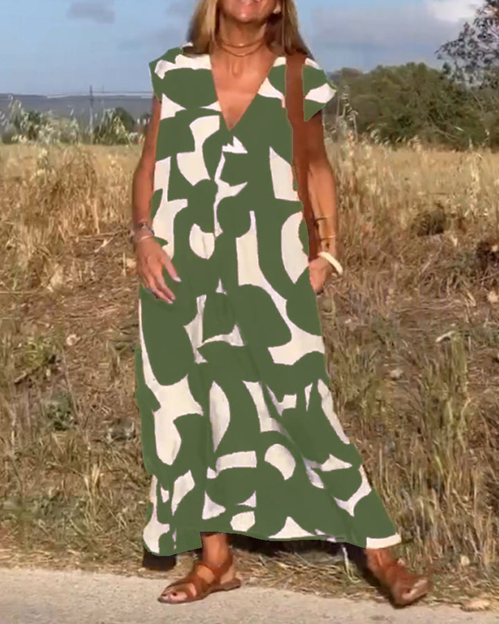 Relaxed fit abstract print dress for women, featuring a flattering V-neck and cap sleeves.