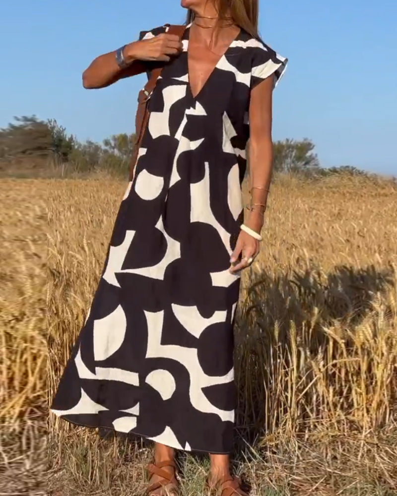 Kendall ladies' printed dress, a comfortable v-neck cap sleeve style for vacation outfits.
