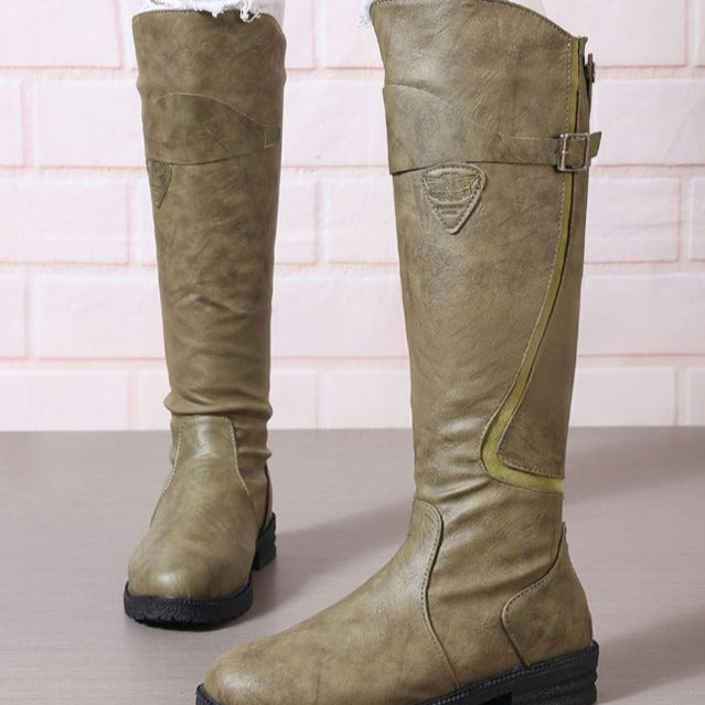 Comfortable women's equestrian style knee-high boots featuring a striking gold buckle and contrast trim.
