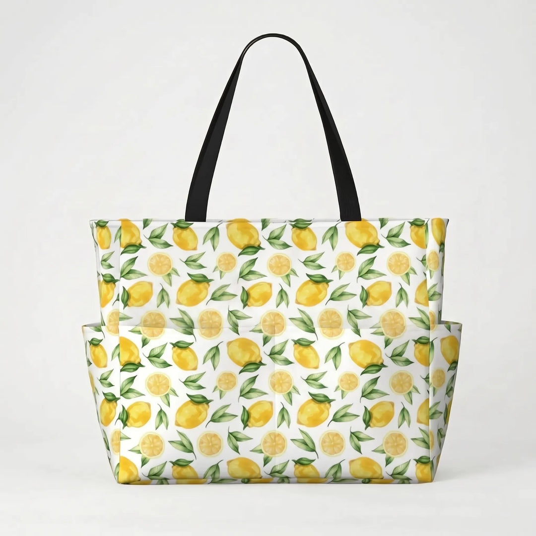Folded women's large beach tote bag with tropical lemon print, showing its compact travel design.