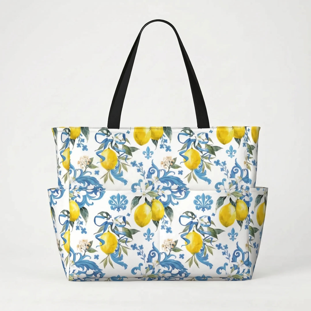Woman carrying a large tropical lemon print beach tote bag on her shoulder, illustrating size & style.