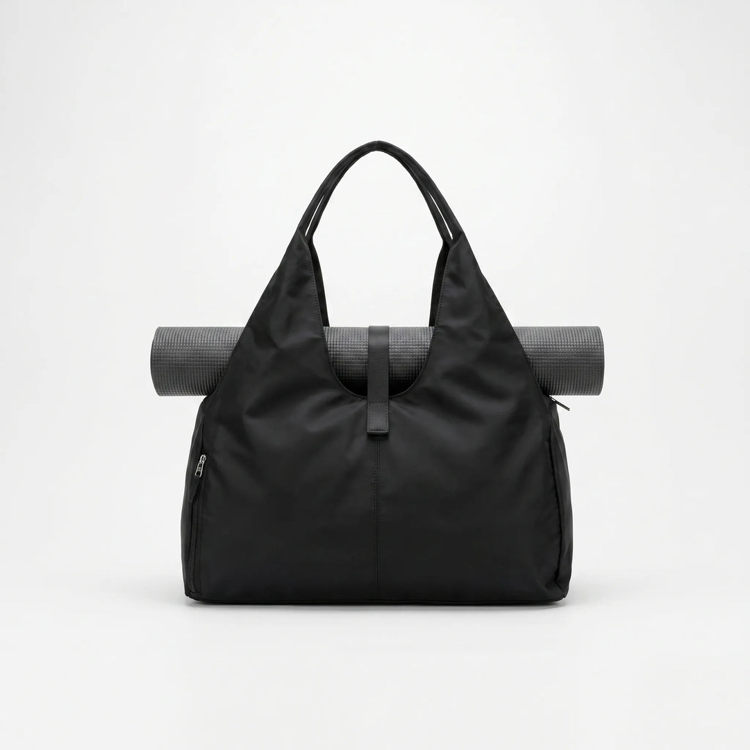 Stylish black women's gym duffel bag, perfect for activewear, yoga, or as a spacious sports tote and weekend travel bag.
