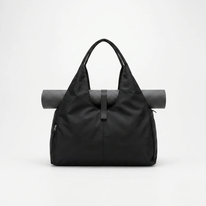 Stylish black women's gym duffel bag, perfect for activewear, yoga, or as a spacious sports tote and weekend travel bag.