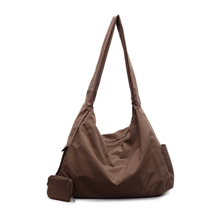 Large capacity women's shoulder bag, easily converts to a crossbody style.