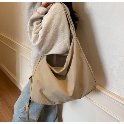 Woman wearing a large capacity slouchy crossbody bag, ideal for daily use.