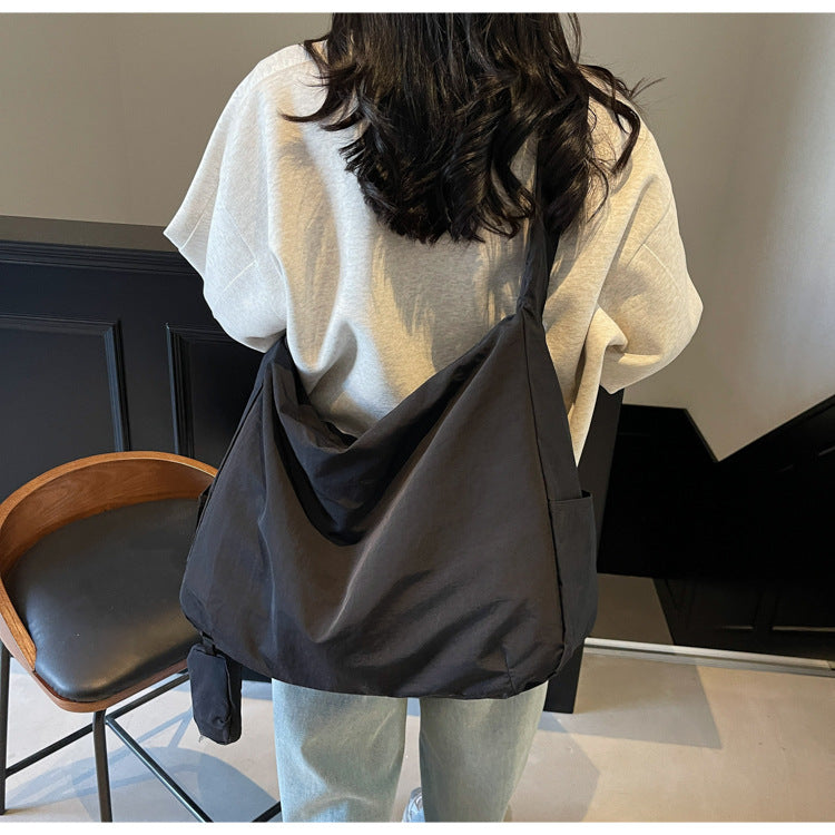 Front view of a women's large capacity crossbody bag, organized & versatile.