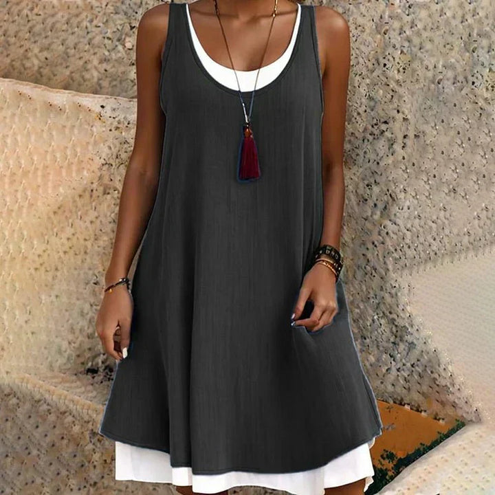 Women's layered mini dress with a sleeveless design and scoop neck, perfect for summer casual wear.