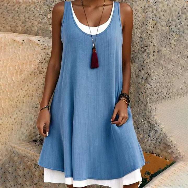 Stylish women's swing mini dress featuring a layered look, sleeveless top, and comfortable A-line fit.