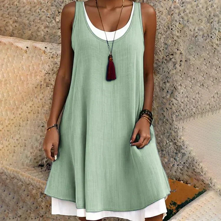 Fashionable women's scoop neck mini dress with a unique two-piece look and breezy sleeveless design.