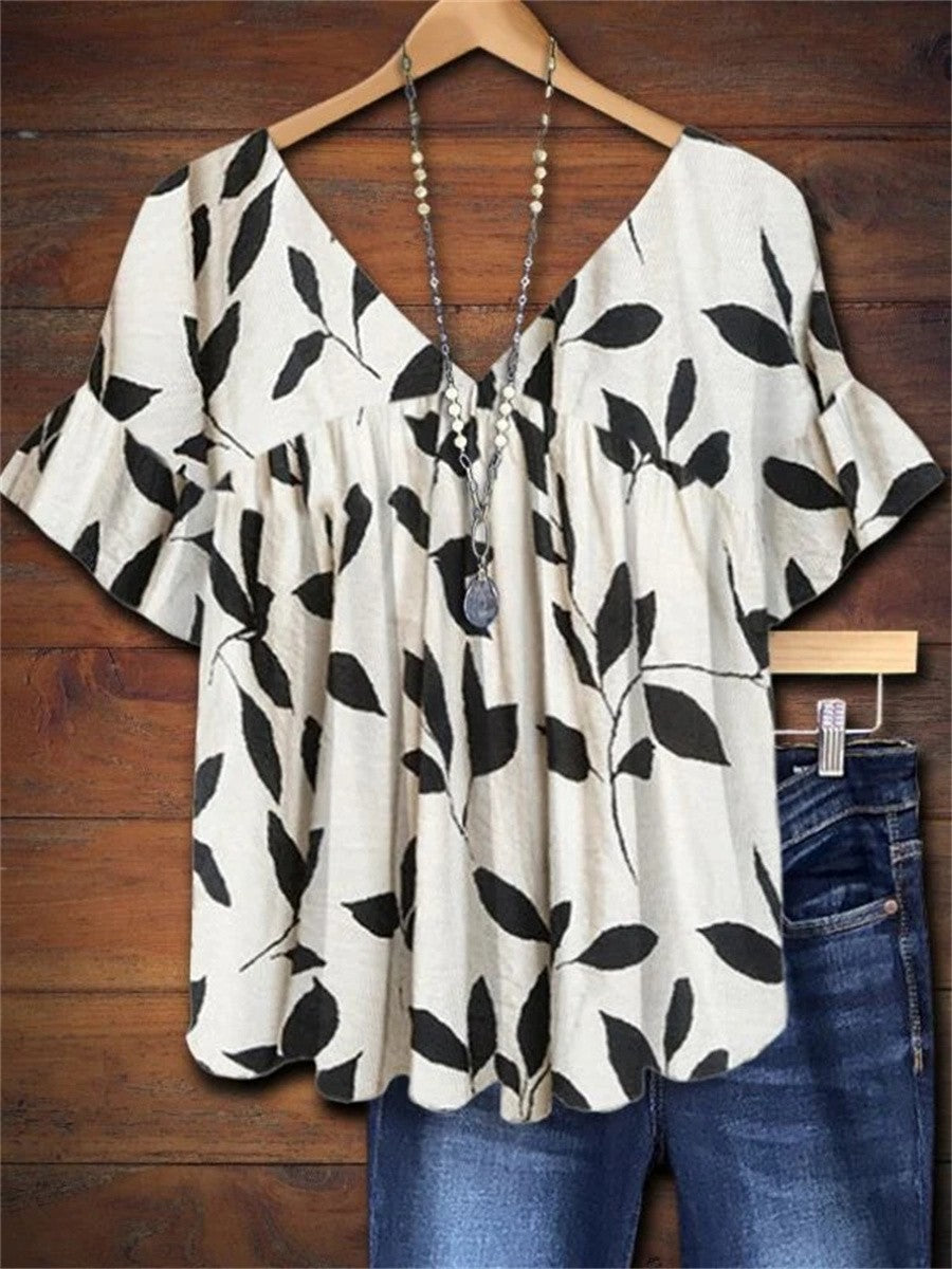 Women's leaf print V-neck blouse with ruffle sleeves, a chic botanical top for spring and summer fashion.