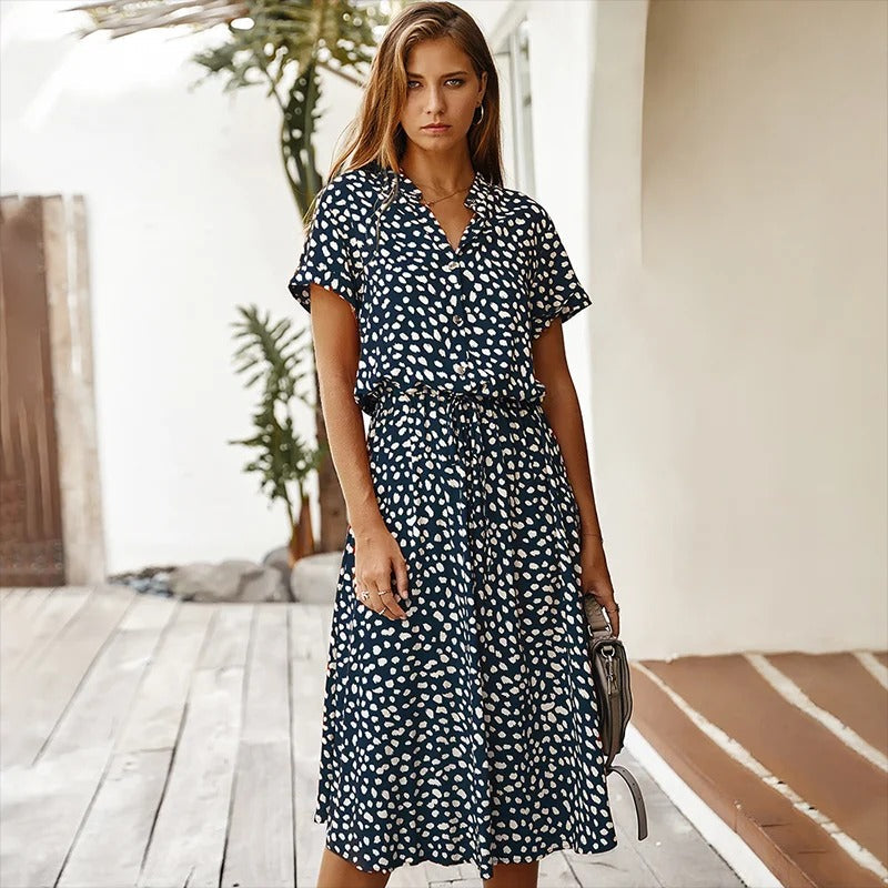 Trendy women's leopard print summer midi dress. A-line silhouette, short sleeves & belted design for vacation wear.