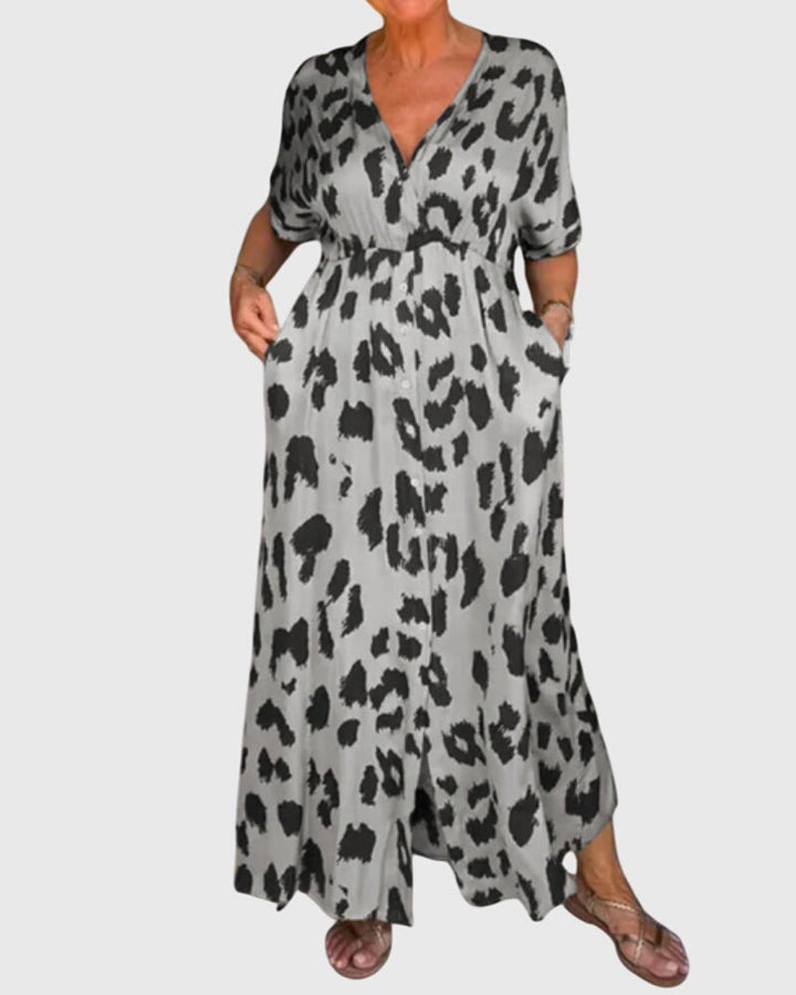 Elegant women's leopard print V-neck maxi dress. Features elastic waist & button front. Comfortable summer wear.