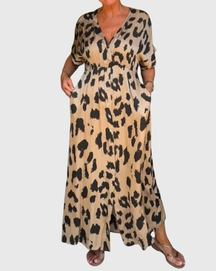 Full length view: Chic women's leopard print maxi dress, V-neck, elastic waist, button front. Flowy summer fashion.