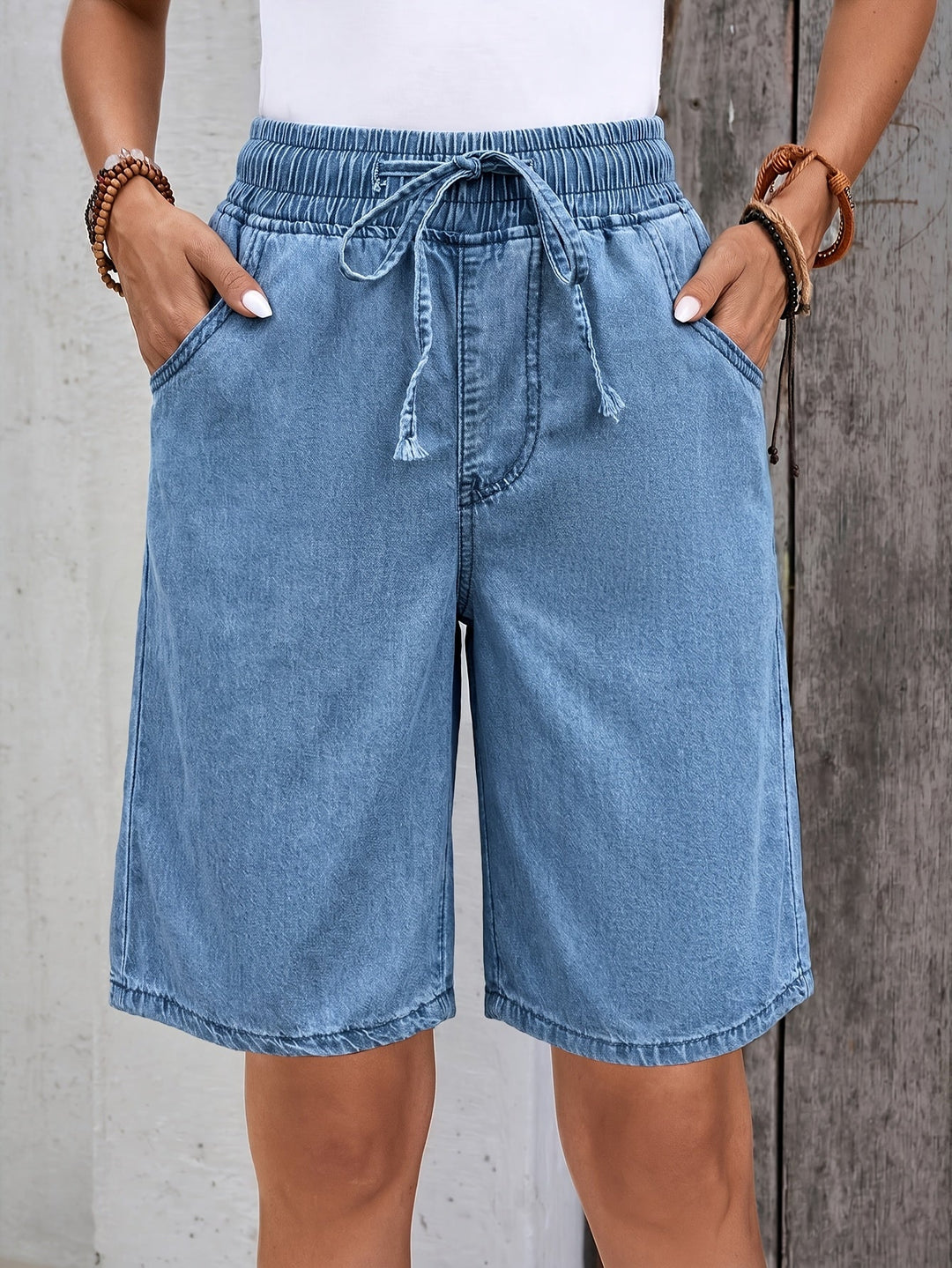Women's light blue Bermuda shorts with elastic drawstring waist, wide leg, perfect for casual summer wear.
