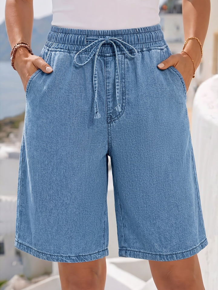 Relaxed fit light blue women's Bermuda shorts, knee-length with comfortable elastic drawstring waist.