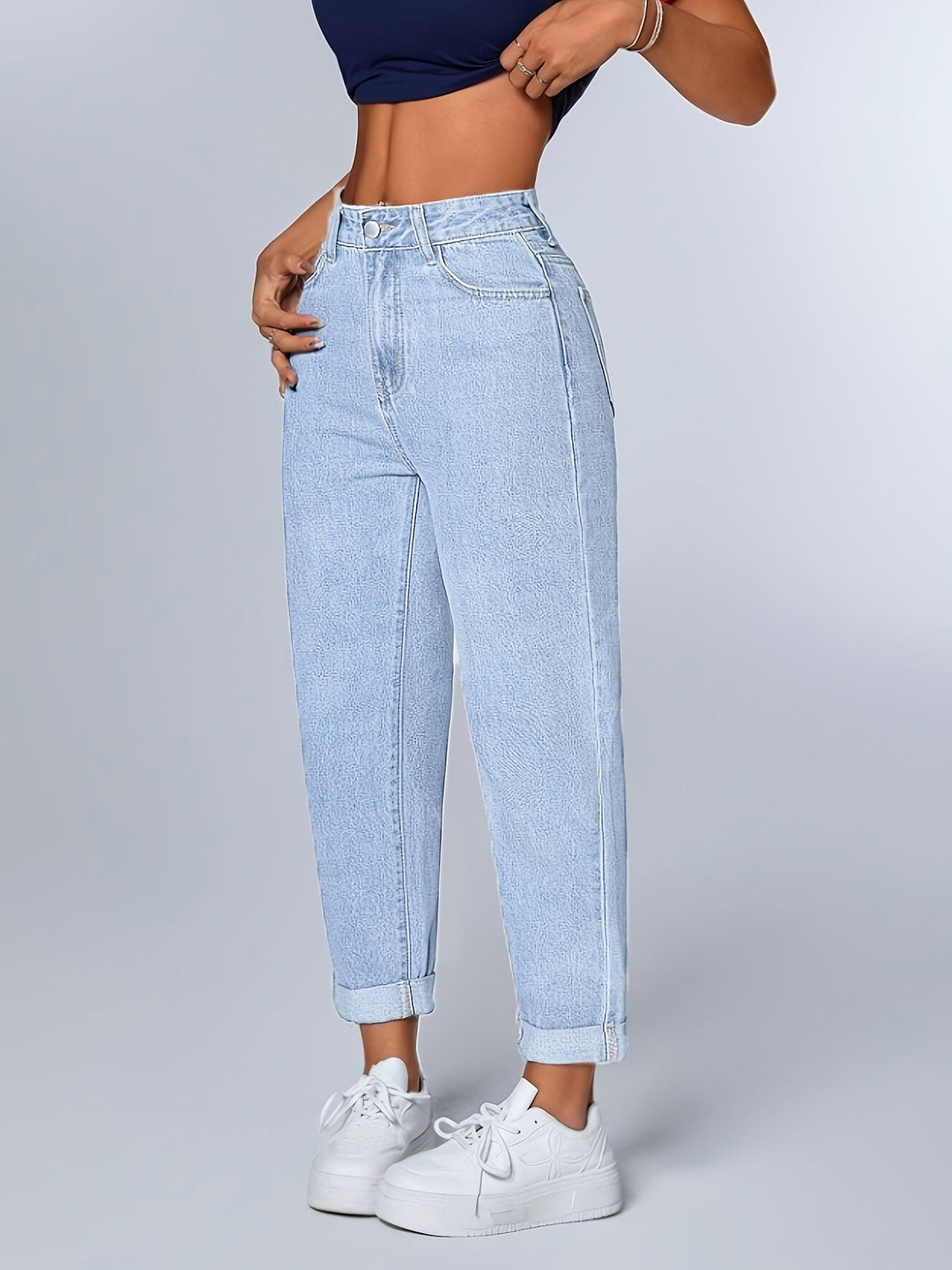 Women's light blue relaxed high waist mom jeans with tapered leg, cuffed hem, perfect for casual retro style.