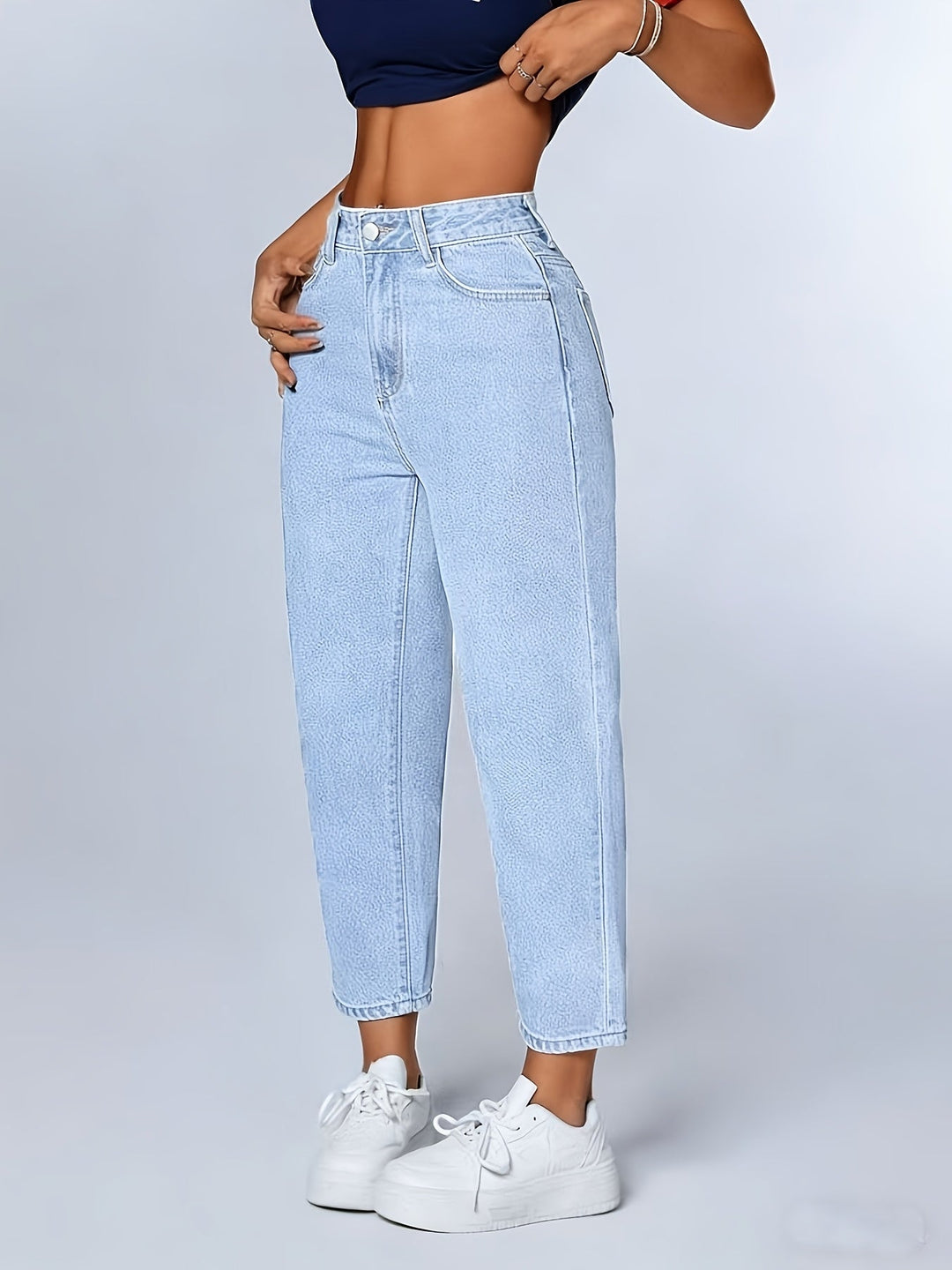 Comfortable women's light blue mom jeans, high waist, relaxed fit, and tapered leg for everyday fashion.