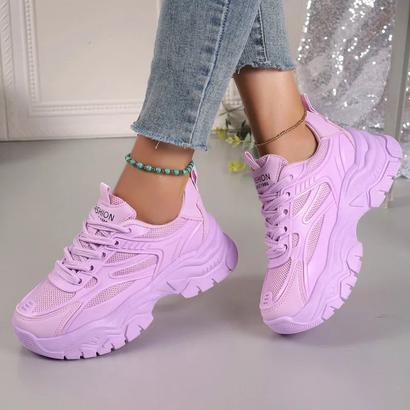 White women's lightweight athletic sneakers with breathable mesh, ideal for walking and everyday comfort.