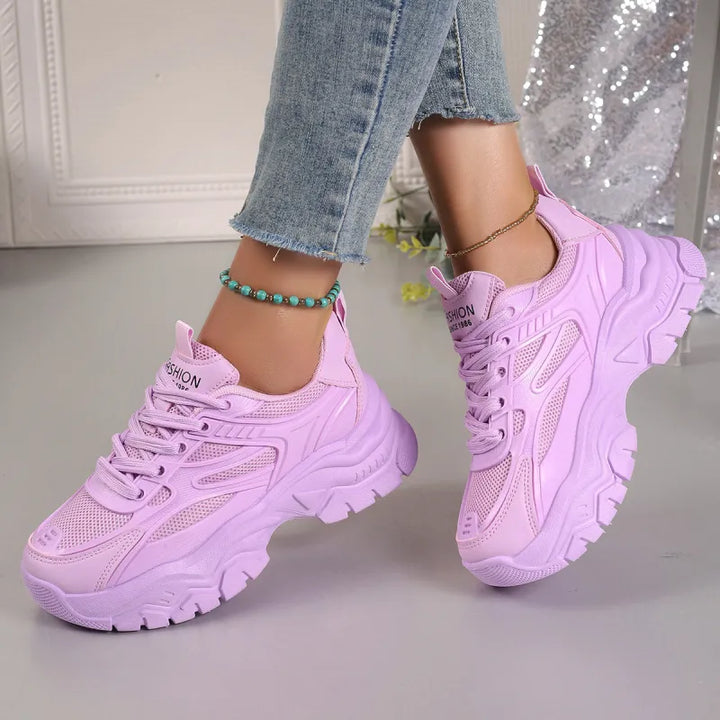White women's lightweight athletic sneakers with breathable mesh, ideal for walking and everyday comfort.