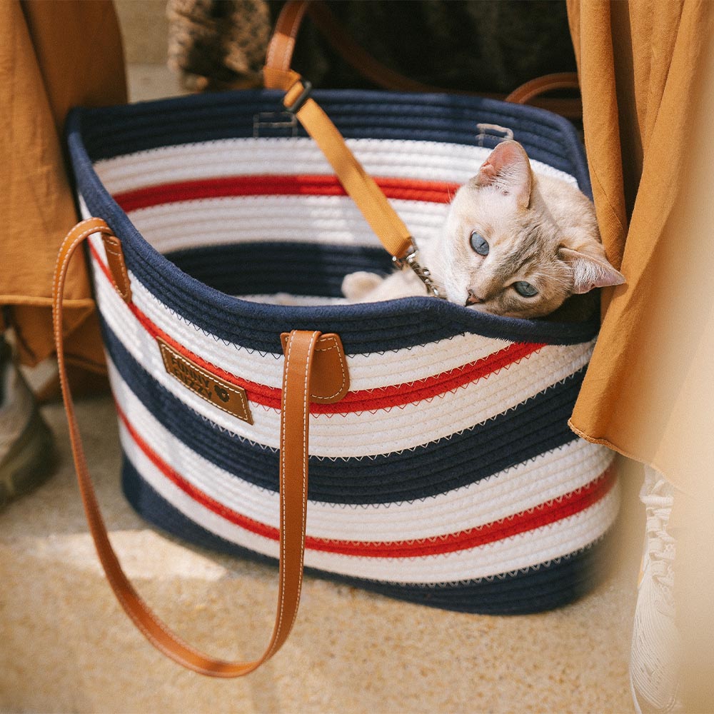 Lightweight cotton woven pet carrier beach bag on a sandy beach, perfect for a sunny day with your pet.