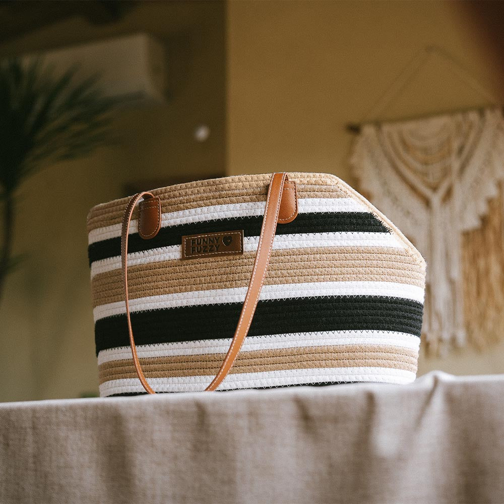 Lightweight cotton woven pet carrier beach bag styled with summer outfit, perfect for beach adventures.