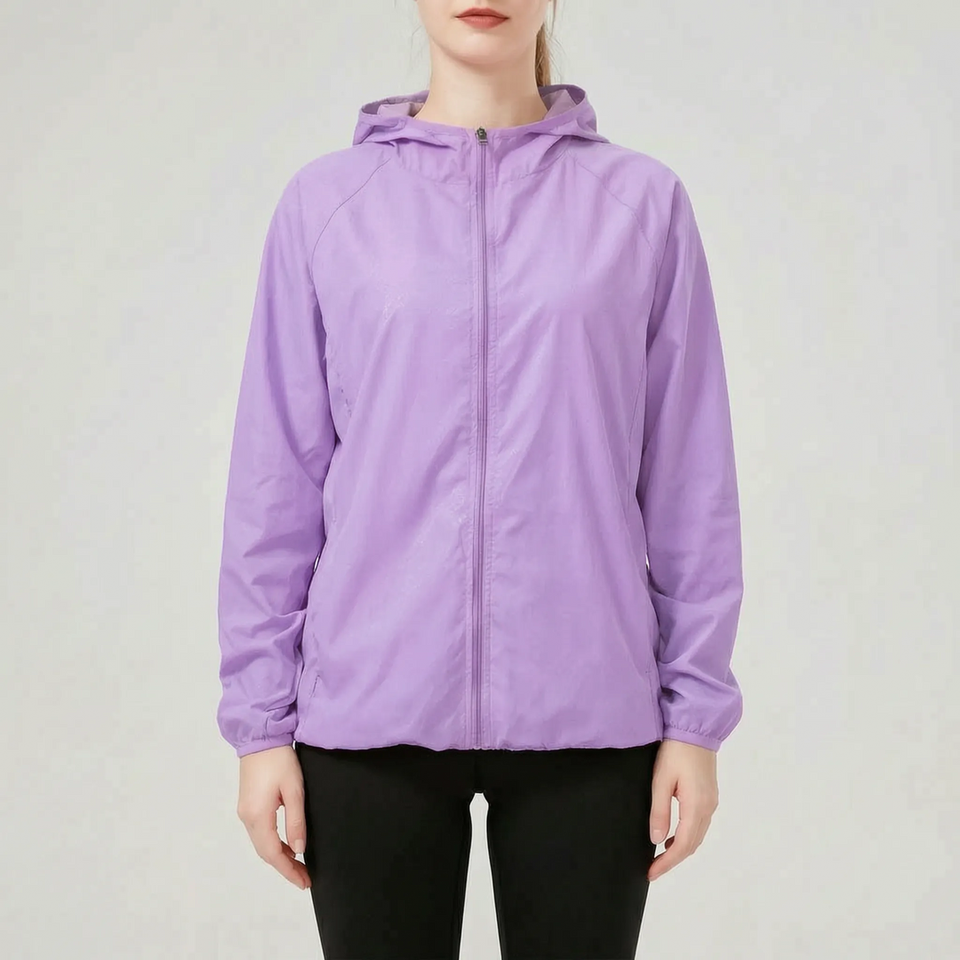 Women's performance hooded jacket. Lightweight, water-resistant windbreaker for athletic and outdoor activities.