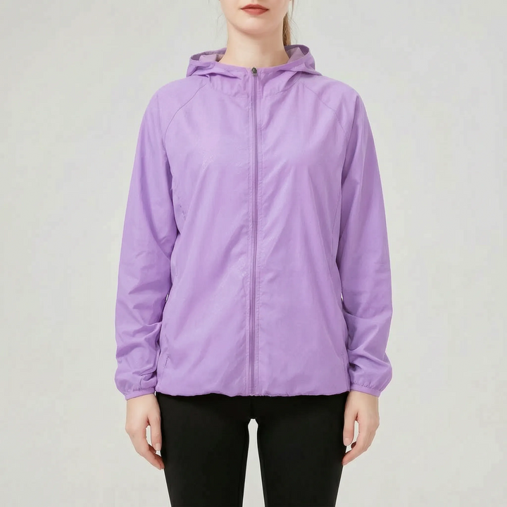 Women's performance hooded jacket. Lightweight, water-resistant windbreaker for athletic and outdoor activities.