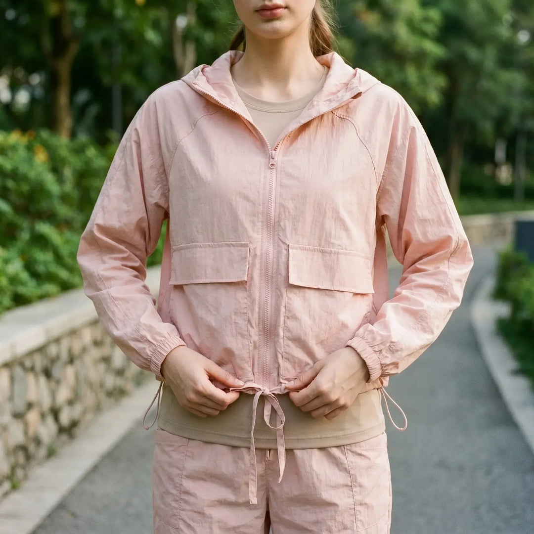 Women's lightweight hooded sports jacket for running & active living. Ideal athletic windbreaker for outdoor workouts.