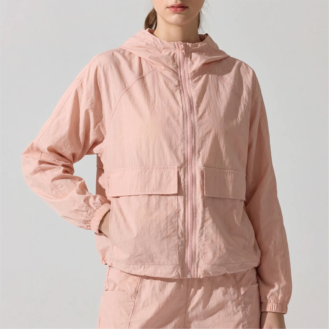 Stylish women's activewear running jacket with hood. Perfect lightweight athletic wear for gym or outdoor sports.