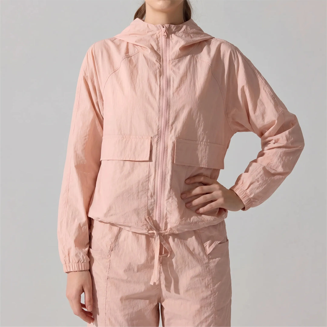 Women's windbreaker jacket with hood for active living. Lightweight athletic wear, perfect for outdoor workouts & sports.