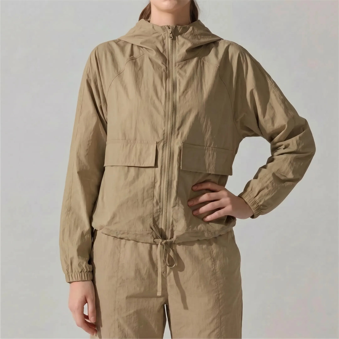 Sporty women's workout jacket, lightweight & hooded. Essential activewear for gym sessions or outdoor athletic pursuits.