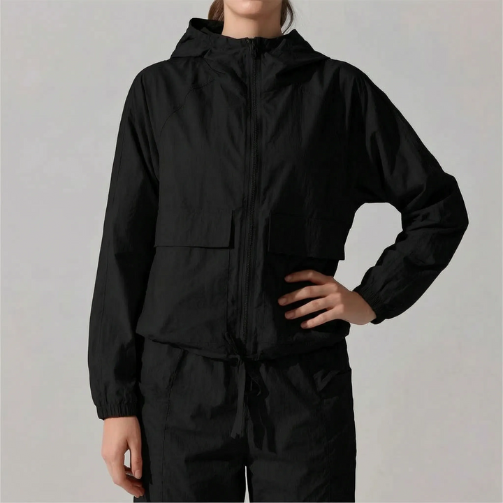Chic women's hooded running jacket, lightweight and functional. Optimal activewear for your daily workout or adventure.