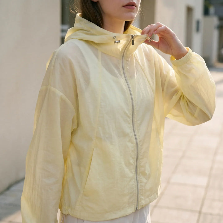 Women's lightweight hooded windbreaker jacket, perfect for spring & summer activewear and casual outings.
