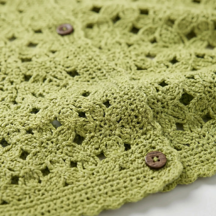 Woman wearing a casual lightweight openwork crochet cardigan in khaki, ideal as a spring/summer coverup.