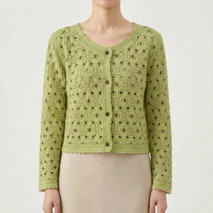 Elegant woman in a beige openwork crochet cardigan, a stylish and lightweight layering piece for spring.