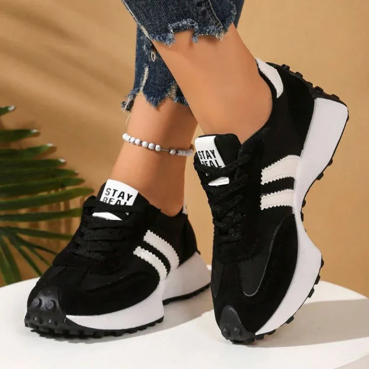 Pink women's supportive sneakers with a wide toe box for all-day wear.